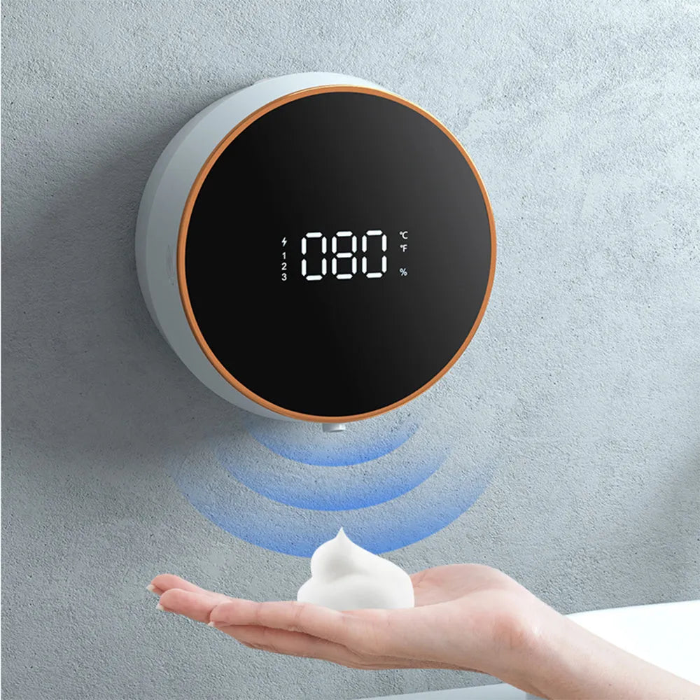 Black smart sensor foam soap dispenser mounted on a bathroom wall.