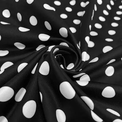 Square collar short sleeve polka dot dress with pleats and a zip on a mid-length skirt.