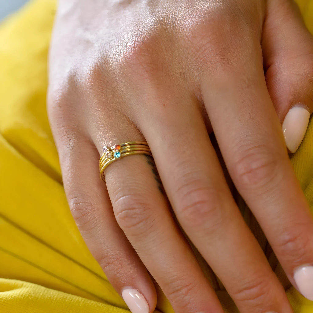 December birthstone geometric engraved ring in titanium steel on a hand.