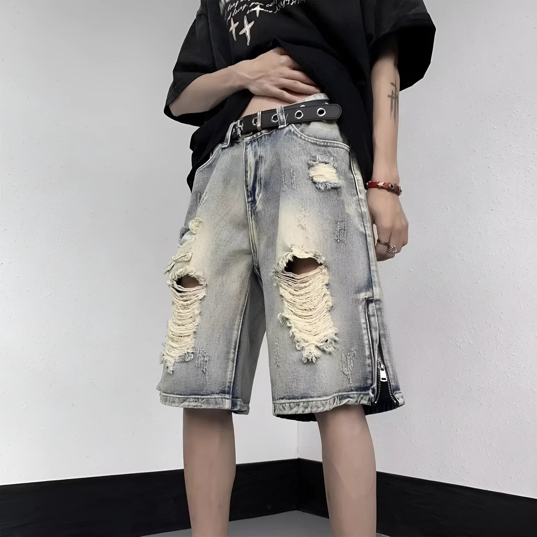 Blue retro tattered denim shorts with wide leg cut on mannequin