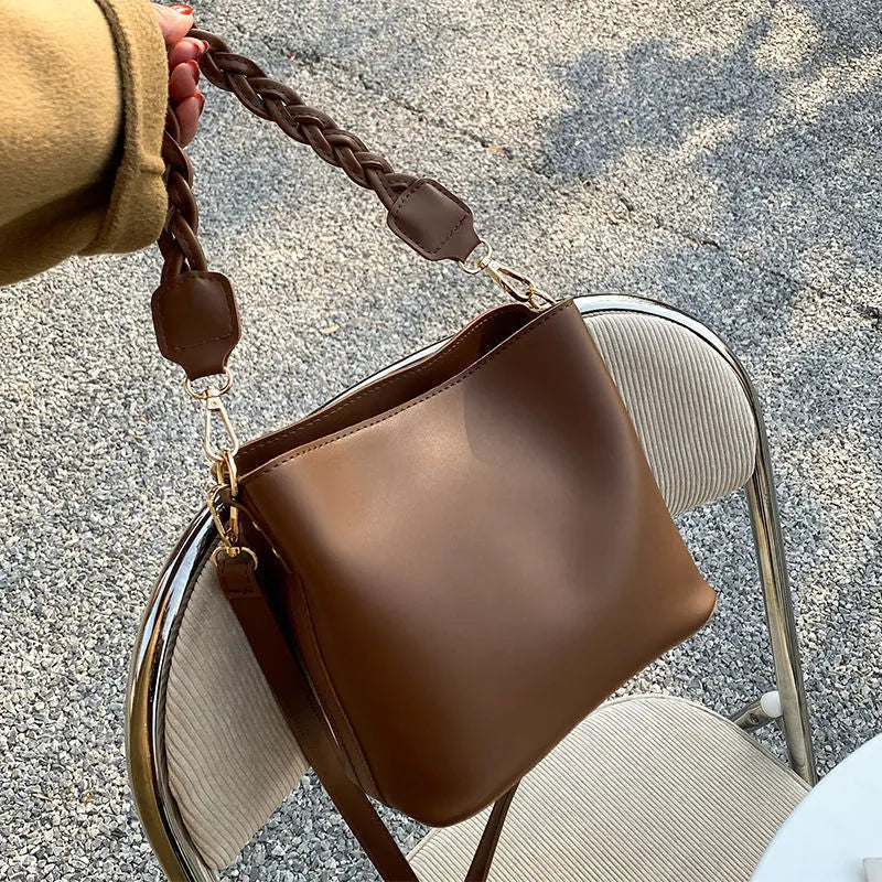 Retro unisex brown PU bucket bag with woven detail, shown with crossbody strap.