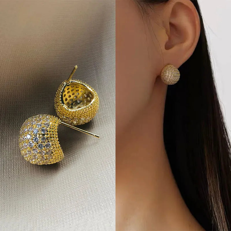 Gold and white geometric drop earrings with flashing lights and spherical elements