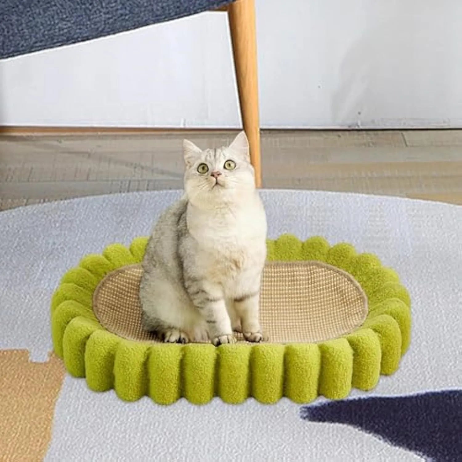 Green oval-shaped cat scratcher pad made of sisal, functioning as both a scratching surface and a lounge bed for cats.