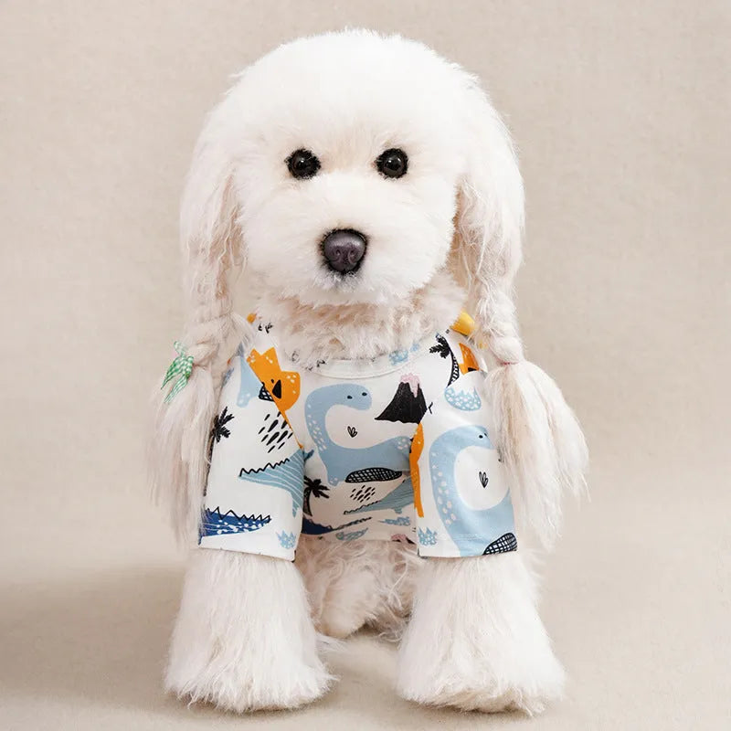 A small dog wearing a casual, printed polyester T-shirt, showing the full design and fit.