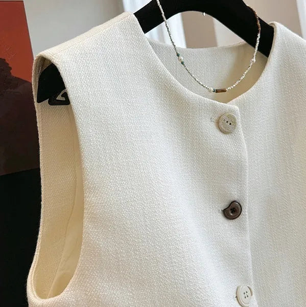 Women's French-style sleeveless bandage vest in beige, shown on a model, with a round neck and fitted silhouette.