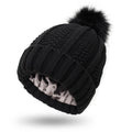 Women's knitted beanie hat with satin lining and a faux fur pom pom in a choice of eight colours.