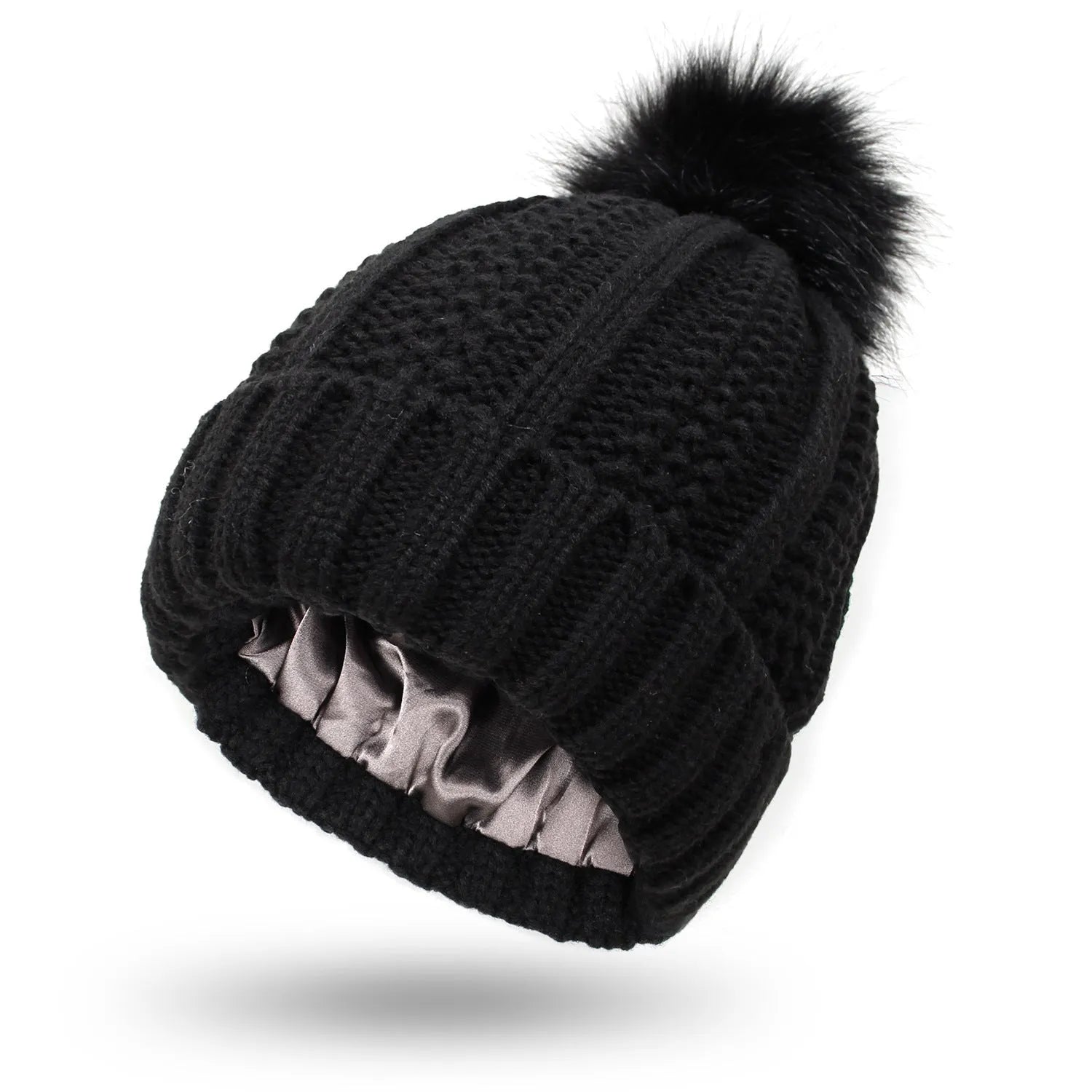 Women's knitted beanie hat with satin lining and a faux fur pom pom in a choice of eight colours.