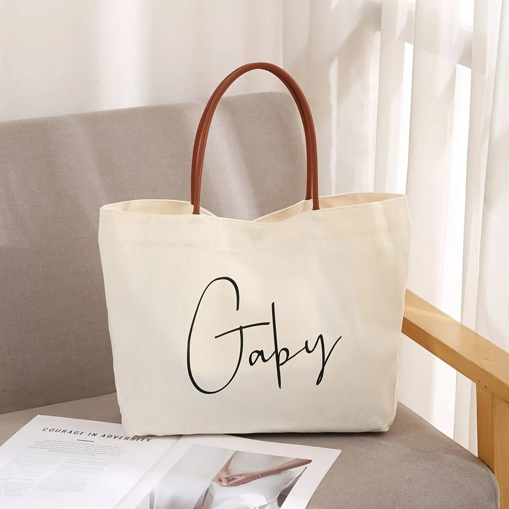 Beige white canvas tote bag with reinforced cotton handles and a flat base.