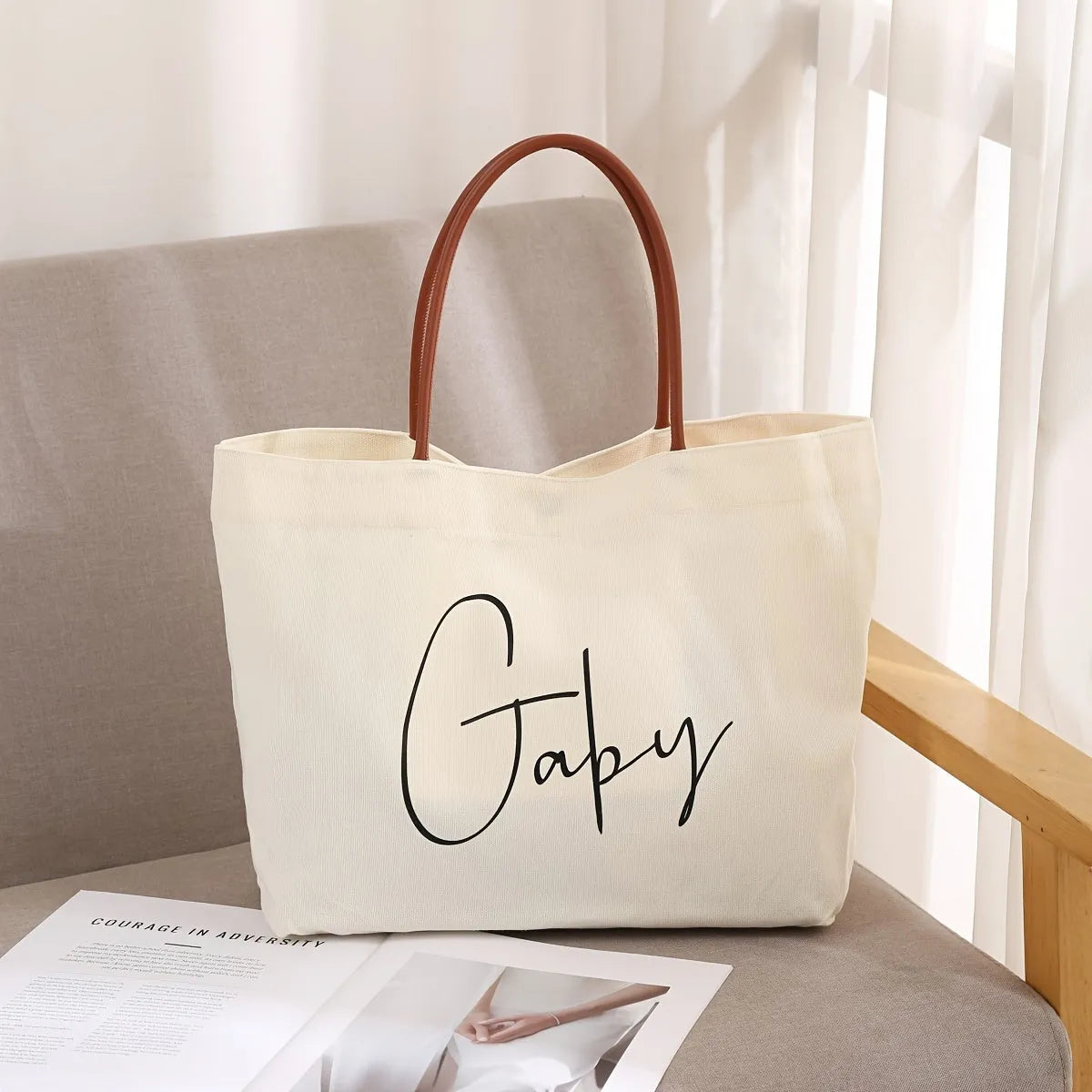 Beige white canvas tote bag with reinforced cotton handles and a flat base.
