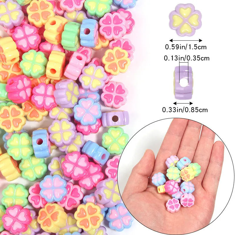 Frosted acrylic four-leaf clover shaped beads in mixed colours on white background