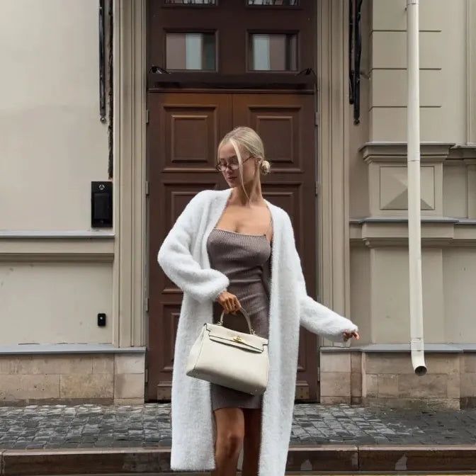 White knitted women's cardigan jacket with extended length and loose fit
