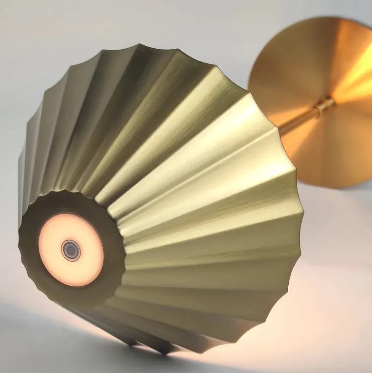 Gold alloy desk lamp with touch control on a wooden desk.