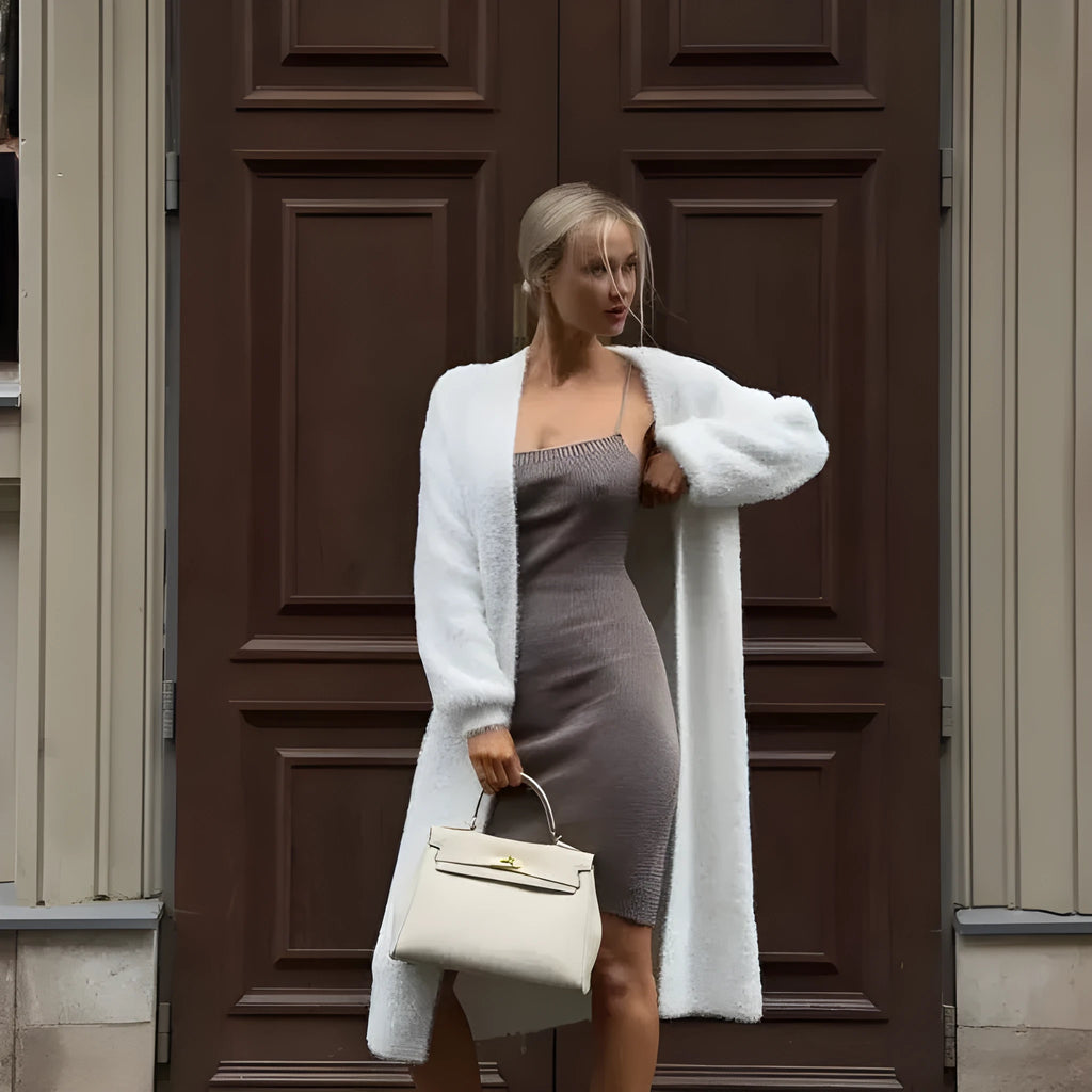 White knitted women's cardigan jacket with extended length and loose fit