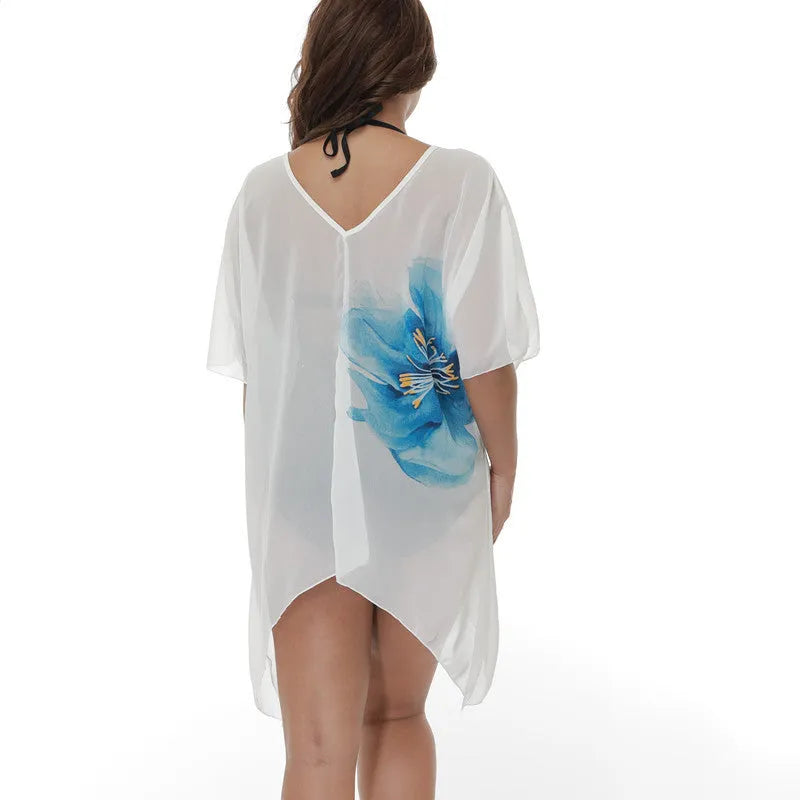 White loose-fit plus size beach cover-up blouse on a hanger.