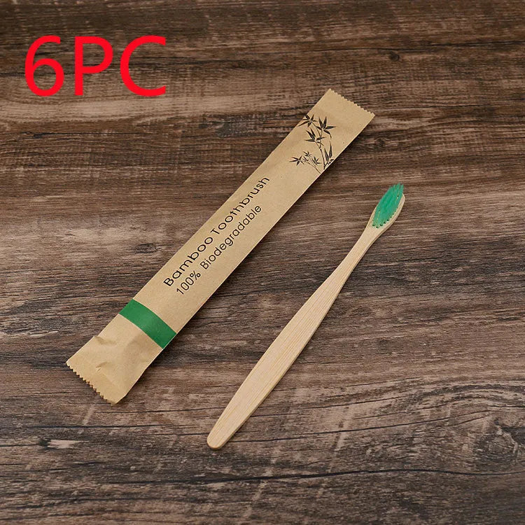 10 bamboo toothbrushes with coloured handles and charcoal bristles displayed together