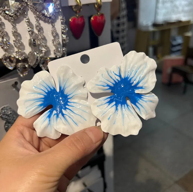 A pair of pastoral style flower stud earrings with an oil-spot glaze finish in an alloy setting.