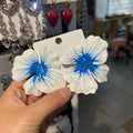 A pair of pastoral style flower stud earrings with an oil-spot glaze finish in an alloy setting.