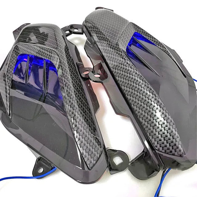 Pair of YAMAHA NMAX scooter side lamps with carbon fibre decoration and blue/red light option.