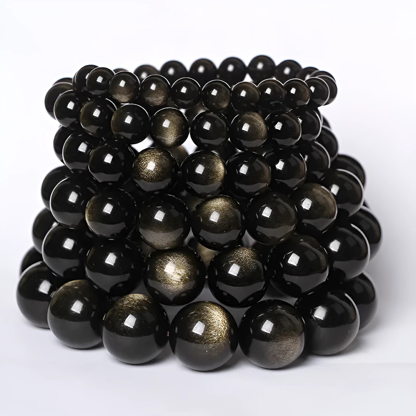 Hand-woven black obsidian bracelet with round beads, shown as a couple's set on a wrist.