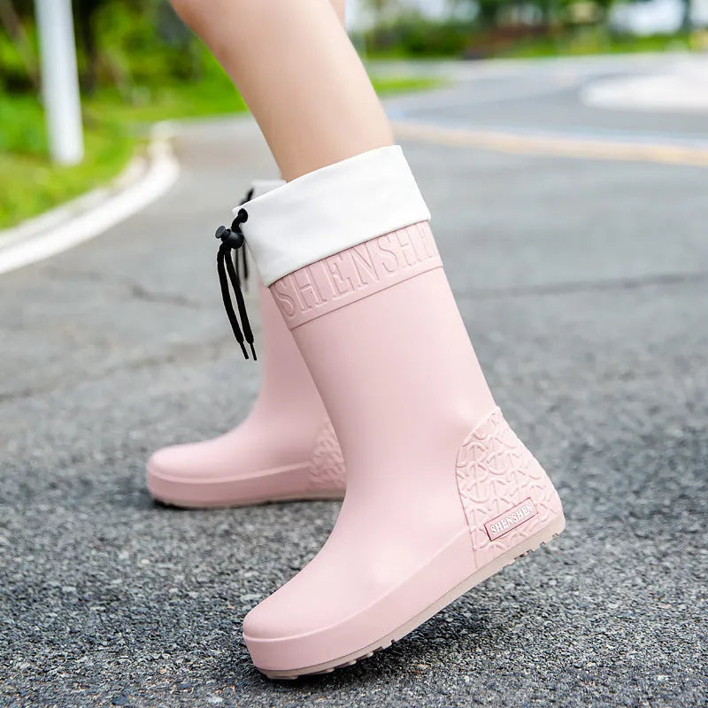 Women's solid colour PVC rain boot in apricot, shown on a white background.