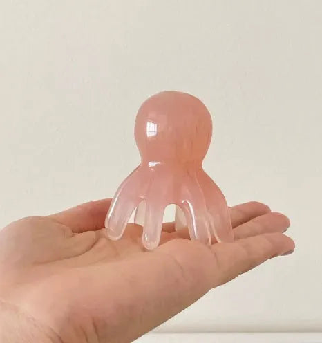 Pink octopus-shaped massage comb made from natural resin with storage bag for facial and head massage