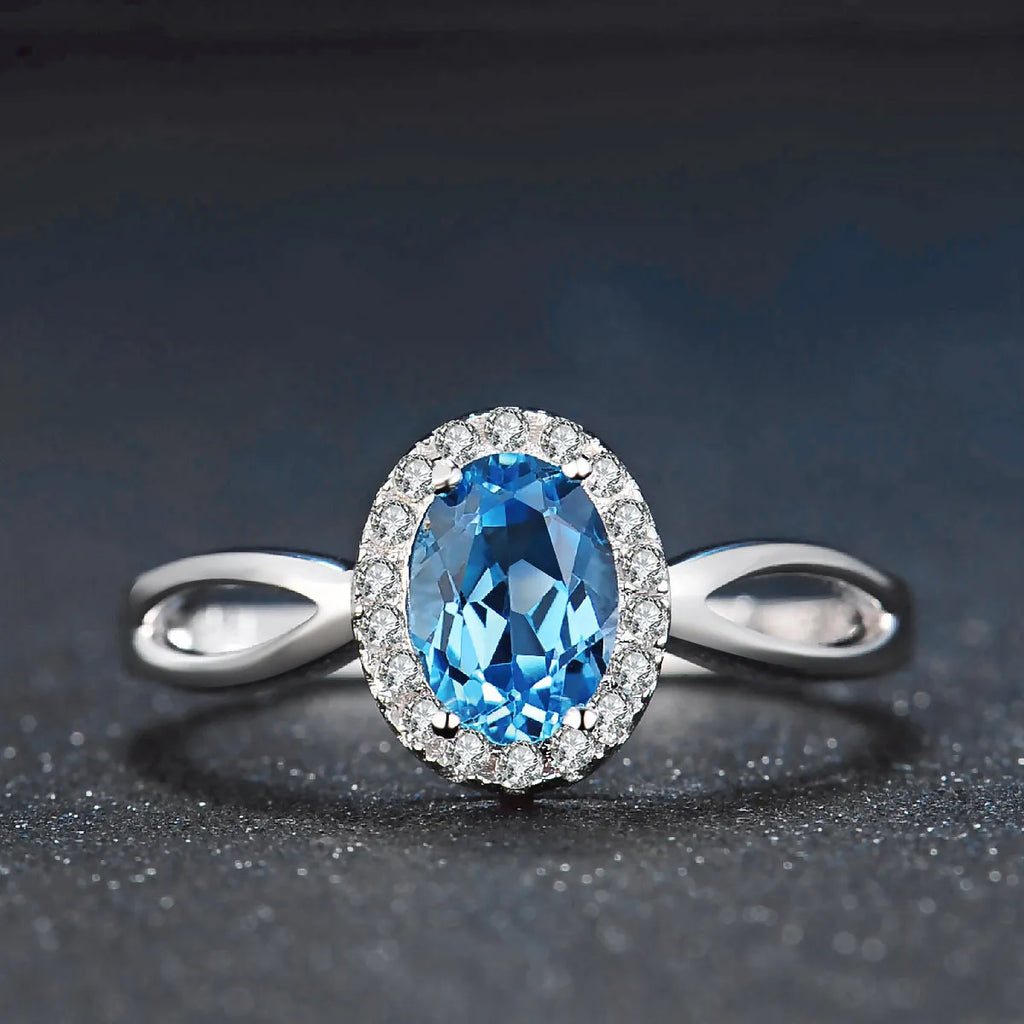 Geometric 925 sterling silver jewellery set with blue topaz stones, showing earrings, ring, pendant and necklace.