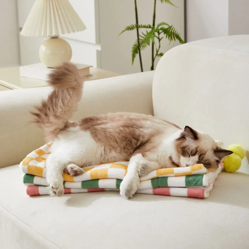 Green plaid pattern pet blanket with decorative fur balls for cats and dogs