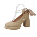 Beige women's Mary Jane shoes with a chunky heel and an ankle-strap buckle on a round toe.