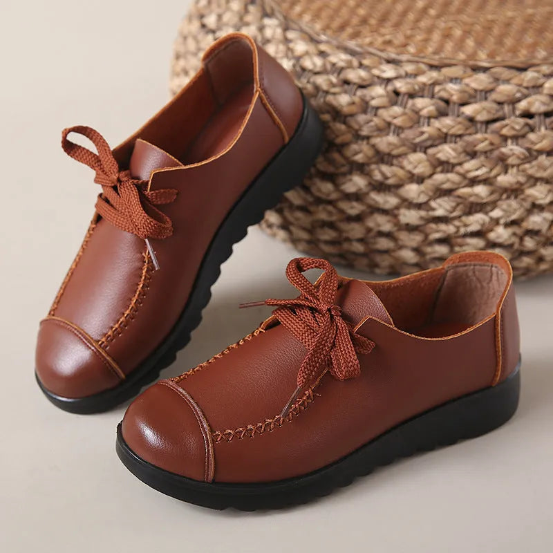 Women's black flat work shoes with round toe, front lacing, and soft anti-slip polyurethane sole