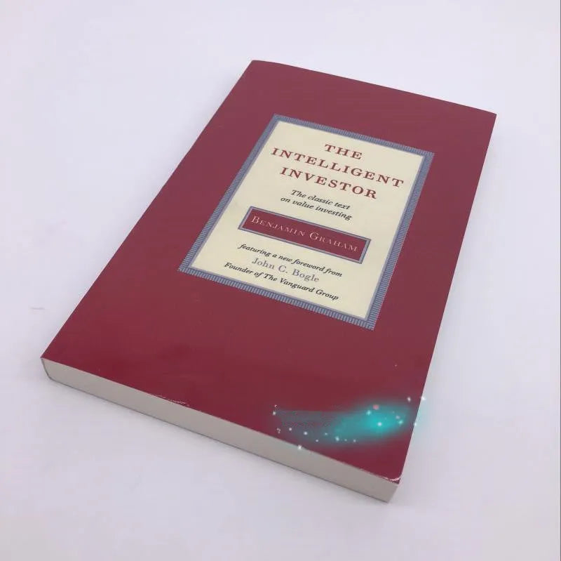Paperback cover of The Intelligent Investor book by Benjamin Graham with Jason Zweig commentary