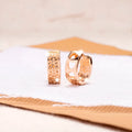 Rose gold hollowed heart earrings with circular shape and electroplated finish
