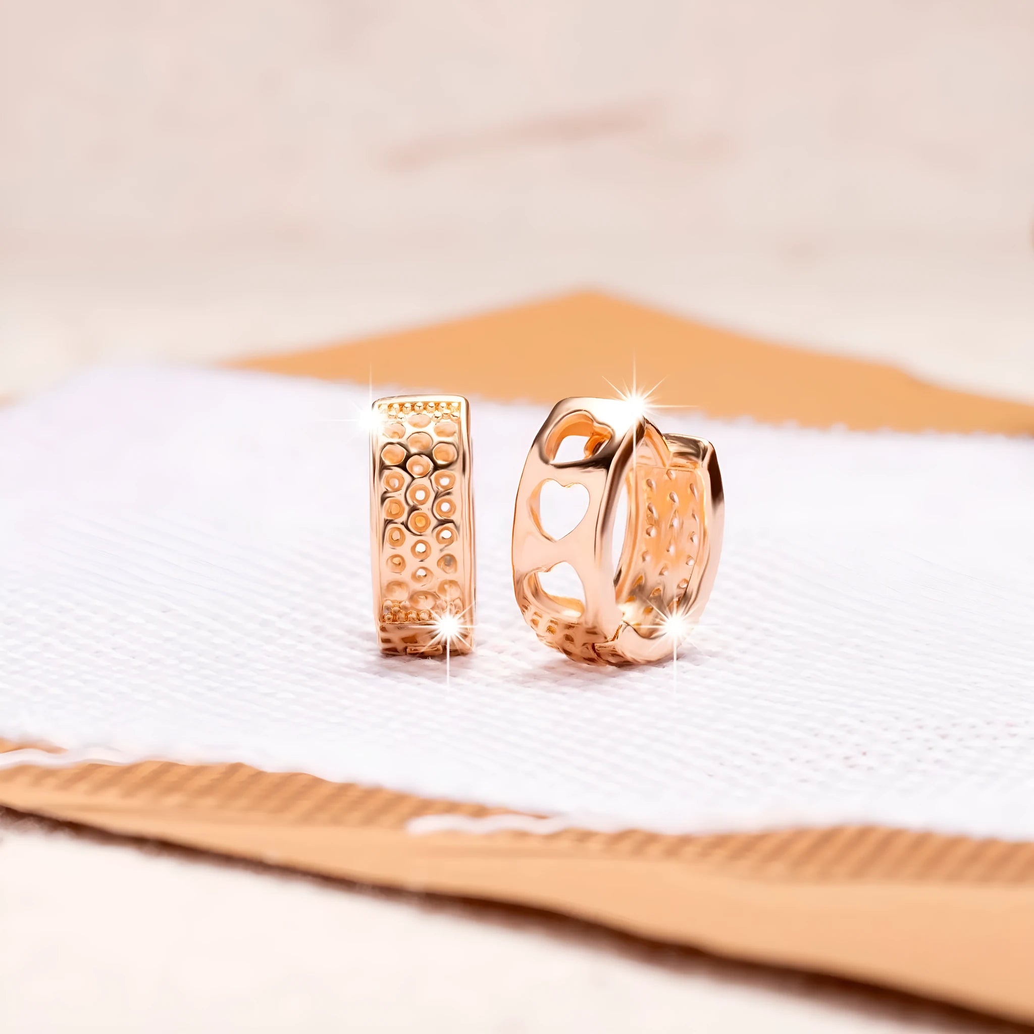 Rose gold hollowed heart earrings with circular shape and electroplated finish