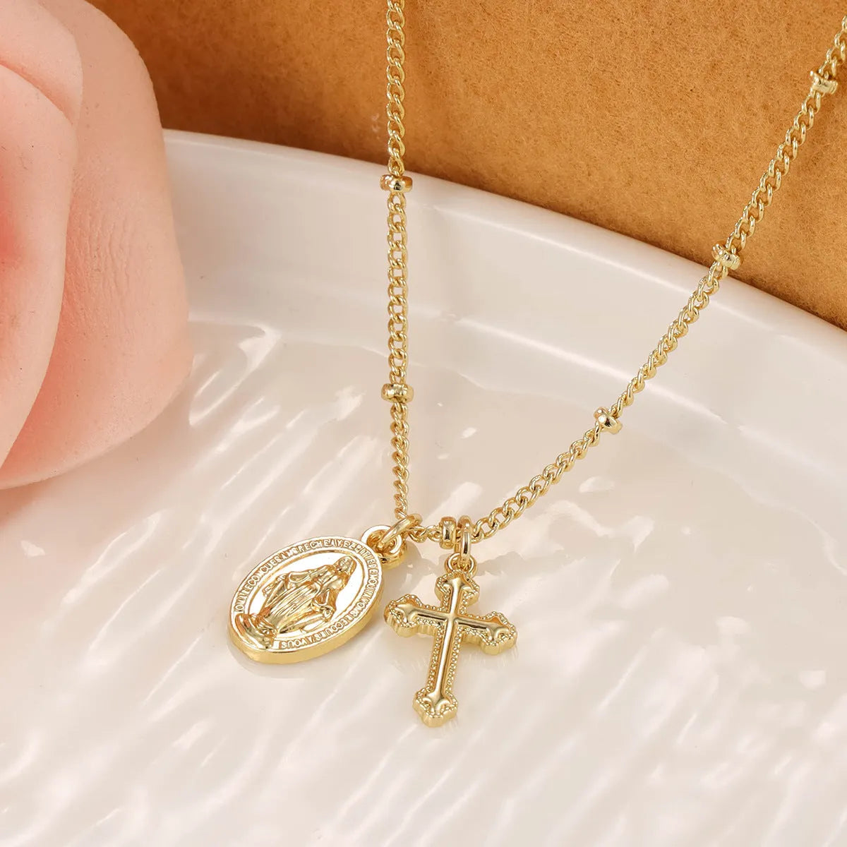 Virgin Mary geometric cross necklace in gold colour with simple styling