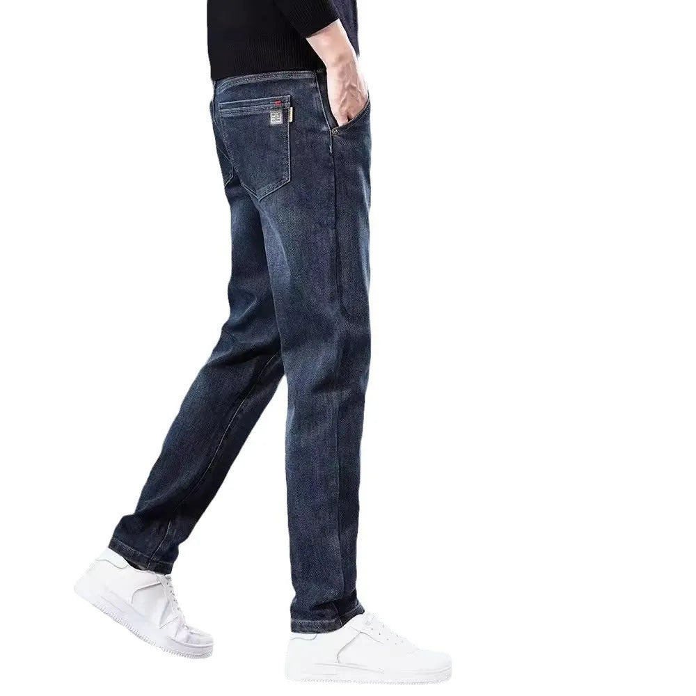 Men's slim straight casual trousers in blue-grey, showing a loose fit and zip fly detail.