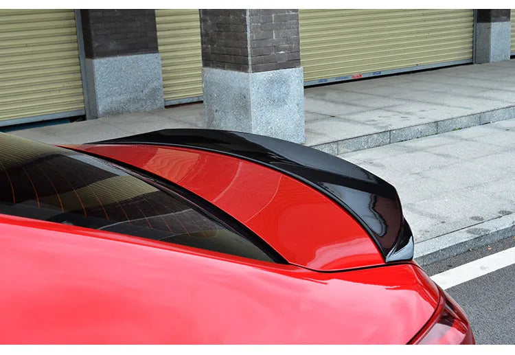 Bright black tail trim for Mazda 3 Exela 2014-2021 models showing large fixed wind-surrounded design