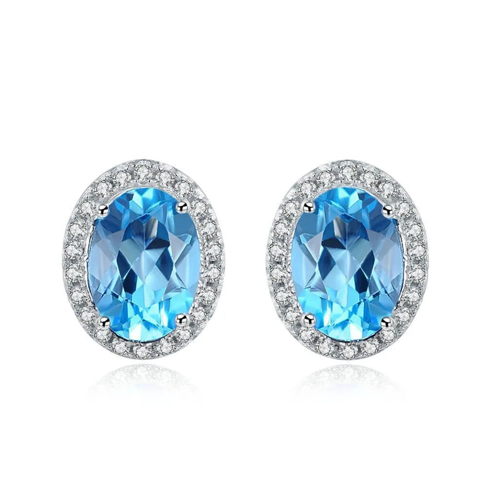Geometric 925 sterling silver jewellery set with blue topaz stones, showing earrings, ring, pendant and necklace.