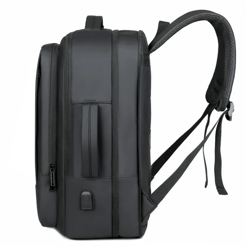 Large black waterproof backpack with curved shoulder straps showing business travel design