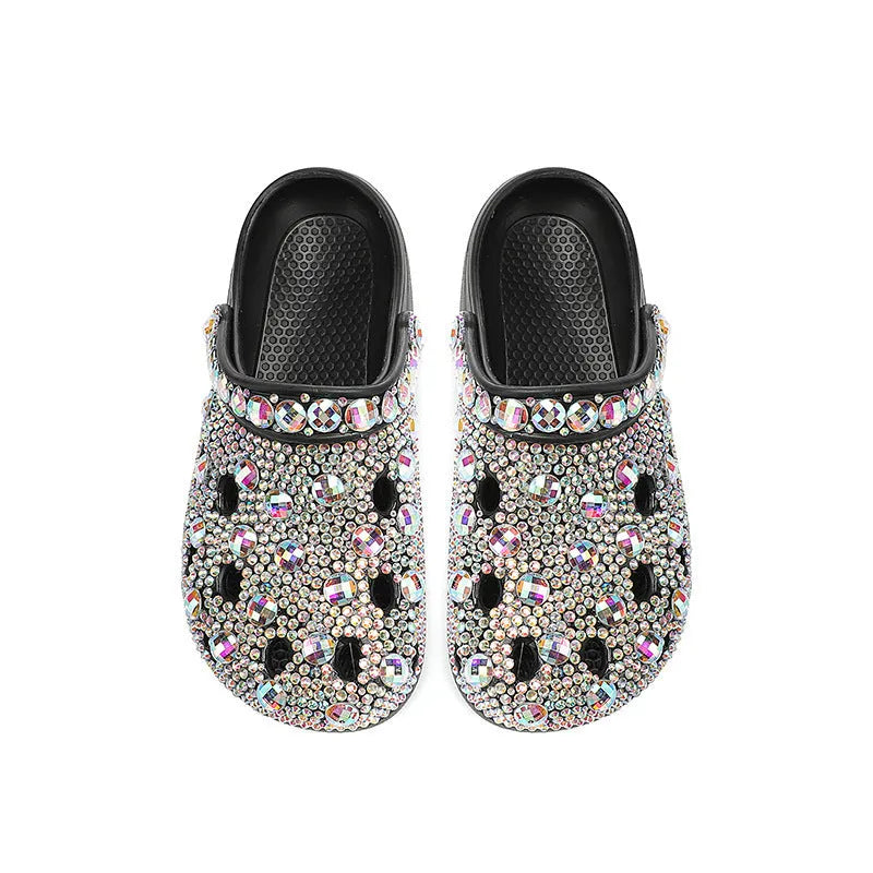 Black women's platform sandals with rhinestone details and a perforated upper on an EVA sole.