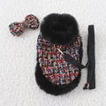 Dog wearing a decorative cloak with a chest strap and attached lead rope