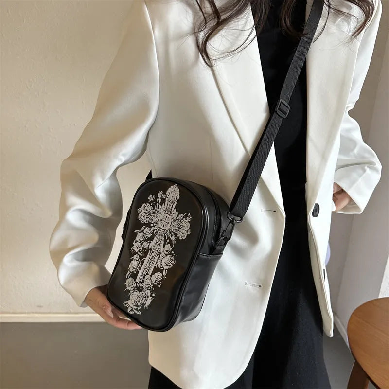 Halloween graffiti crossbody phone bag with cartoon pumpkin, ghost, and bat print in black.