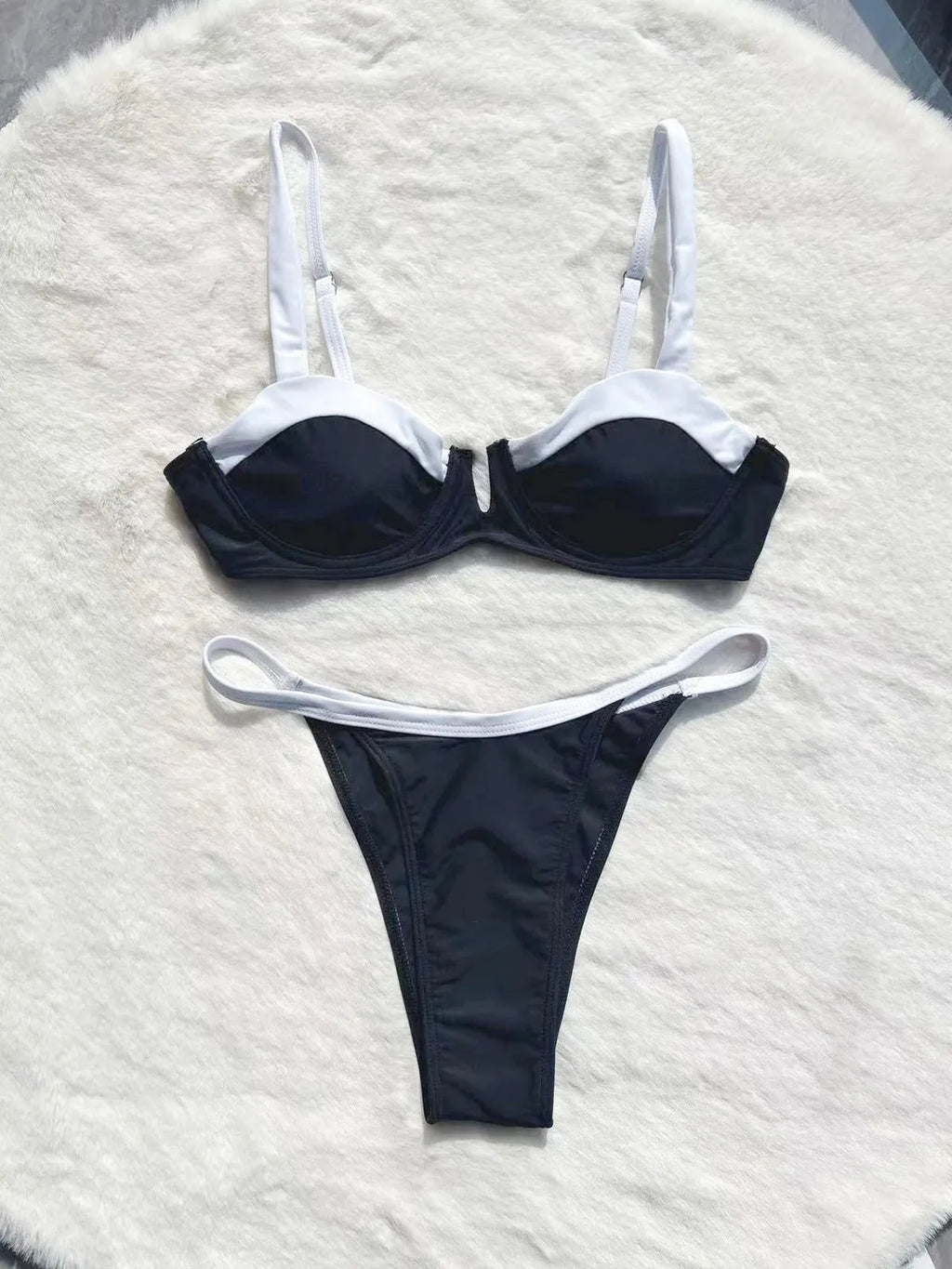 Black low waist bikini swimsuit with stitching split design on mannequin showing front and back views