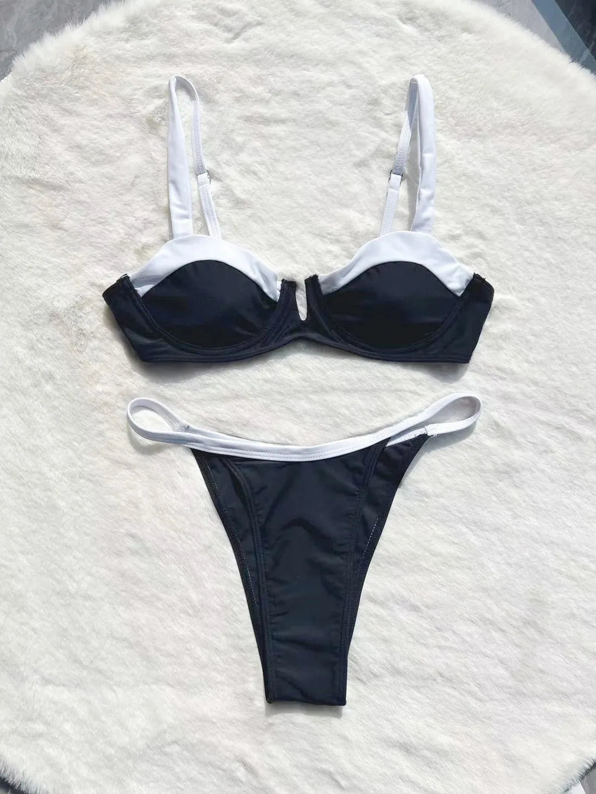 Black low waist bikini swimsuit with stitching split design on mannequin showing front and back views