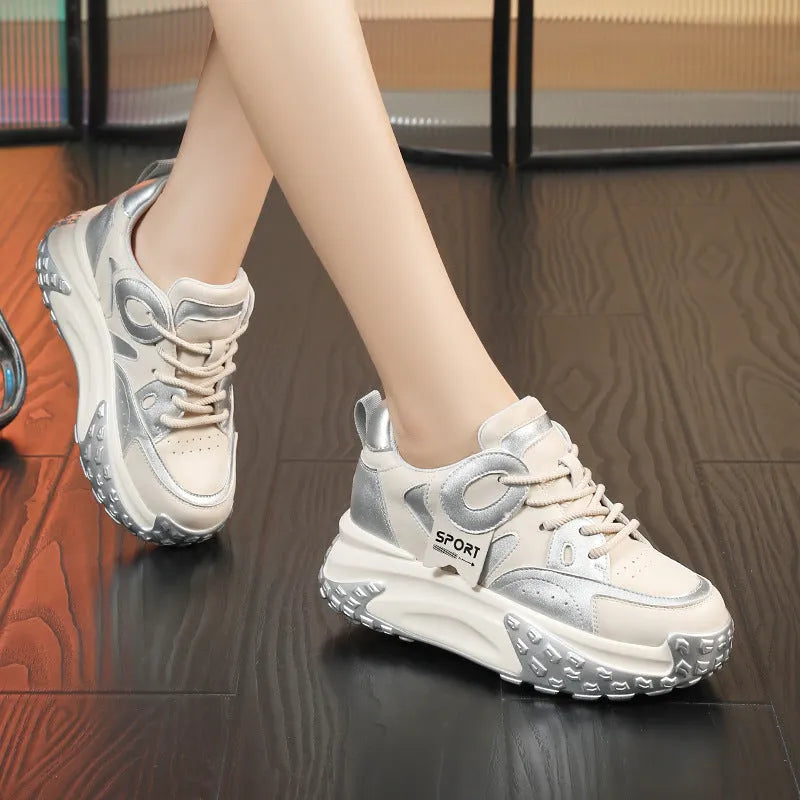 Women's leather sports casual shoes with thick sole and lace-up front in black and white colour.