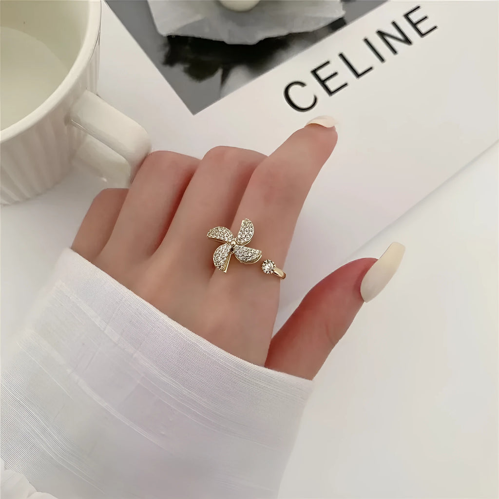 Rotating geometric ring with spinning windmill design in gold or silver electroplated finish