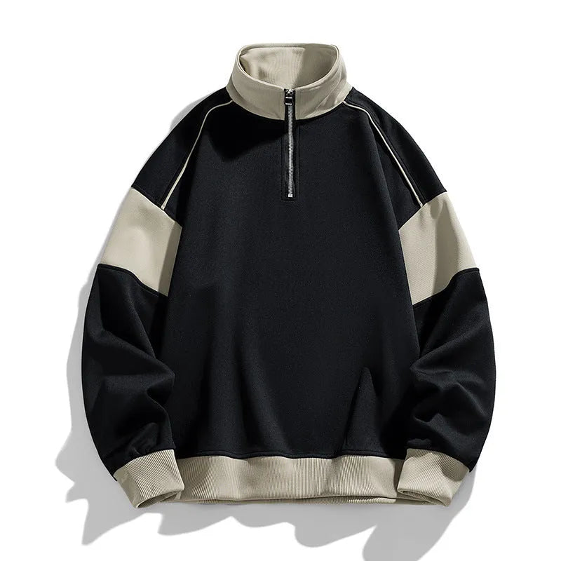 Man modelling a hooded black corduroy sweatshirt with drop shoulders and loose lapels.