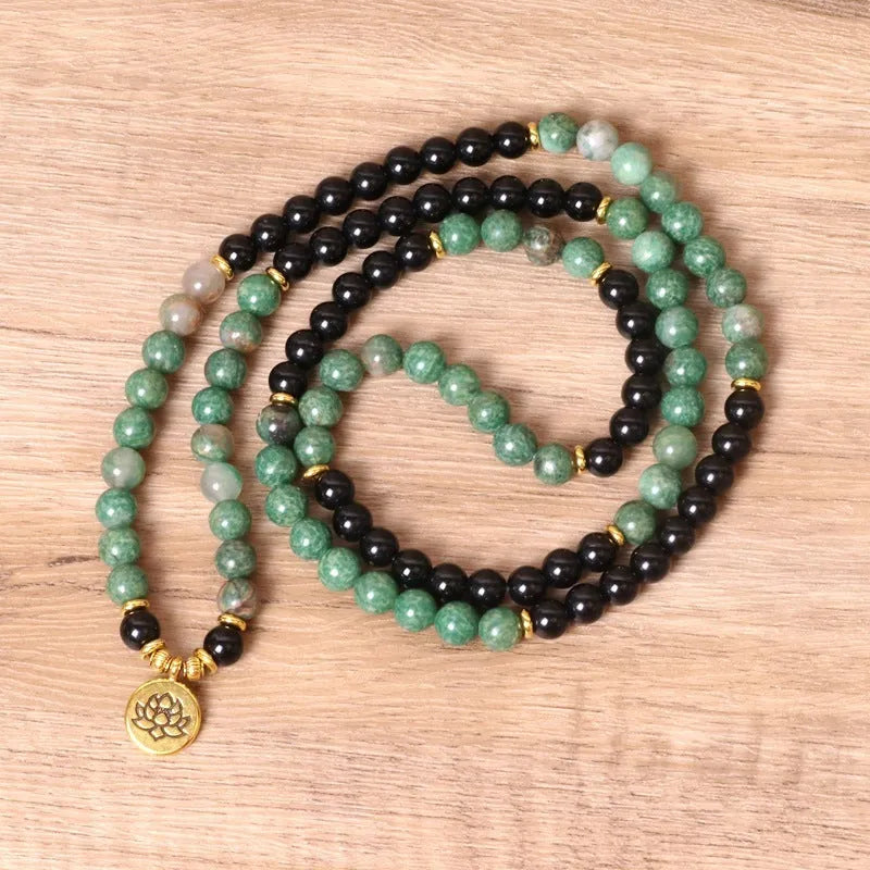Green and black alloy beads on a stretch elastic bracelet band.