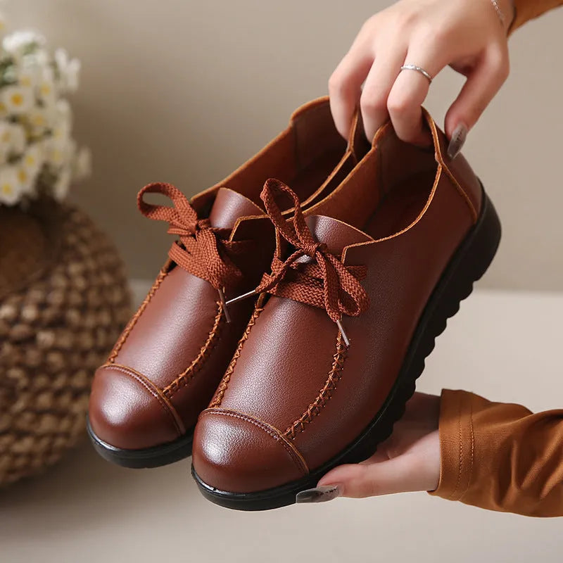 Women's black flat work shoes with round toe, front lacing, and soft anti-slip polyurethane sole