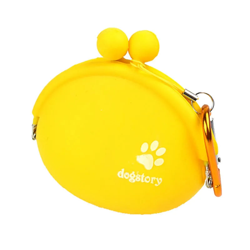 Yellow silicone dog training treat pouch with hook-and-loop strap, shown attached to a waistband.