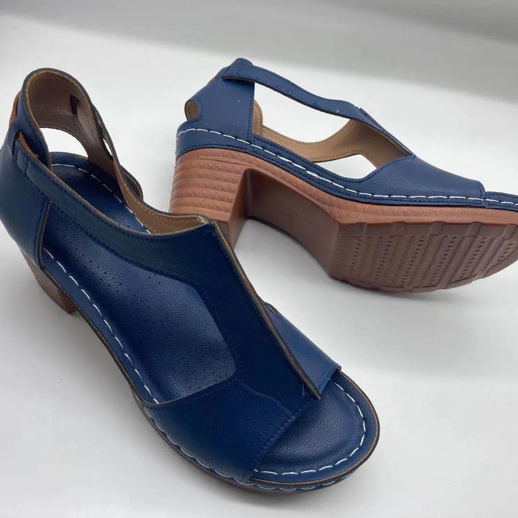 Women's beige peep toe wedge sandals with a buckle ankle strap and low rubber sole.