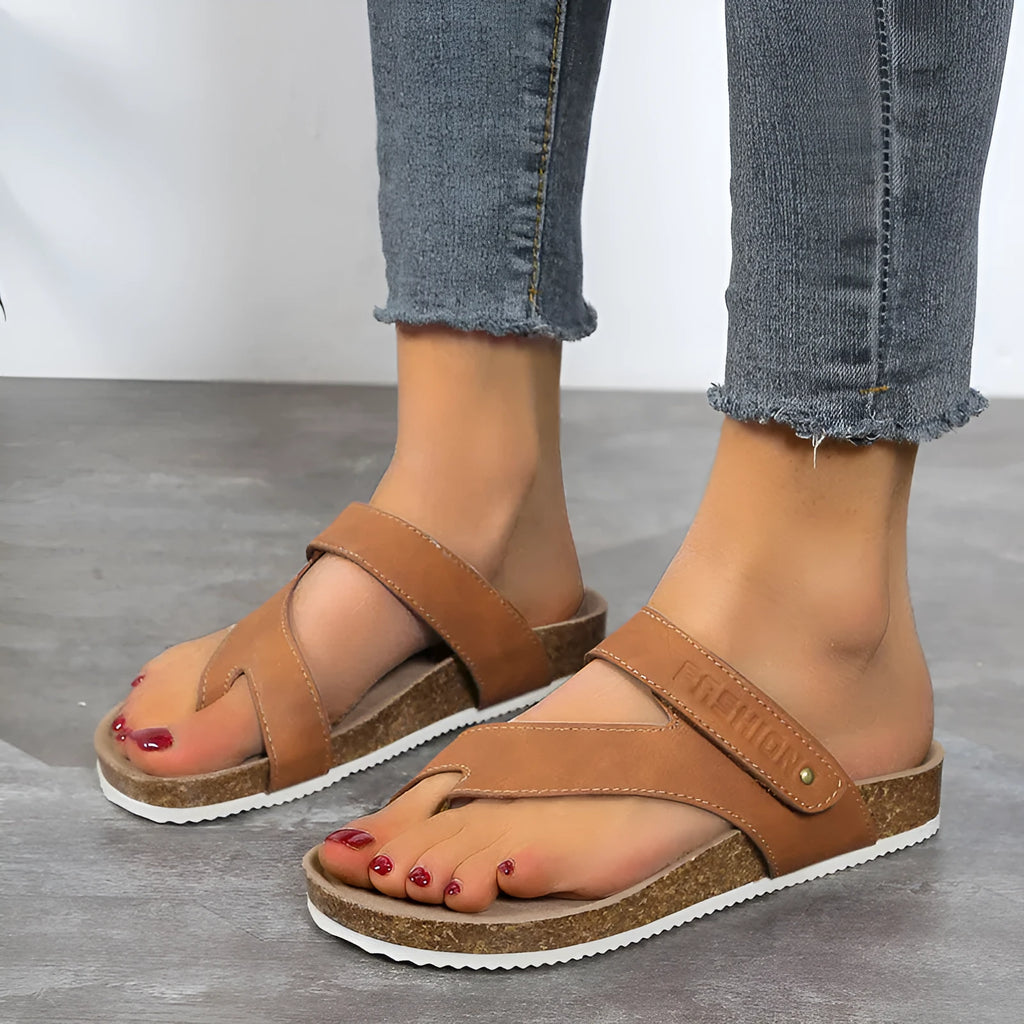 Solid colour thick-soled flat toe ring flip-flops on a white background.